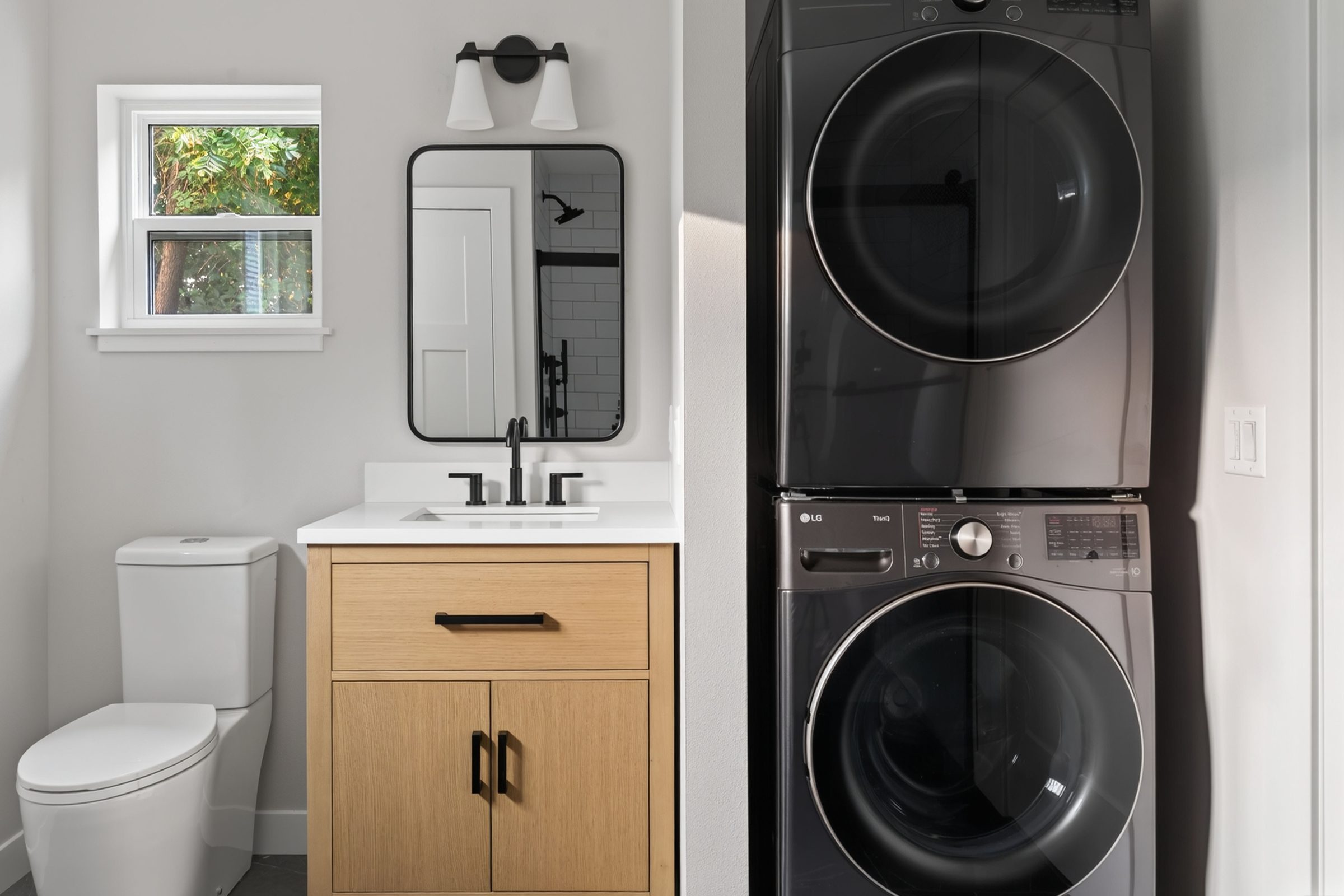Bathroom vanity with the stacked washer and dryer beside it — aging-in-place ADU, Madison WI