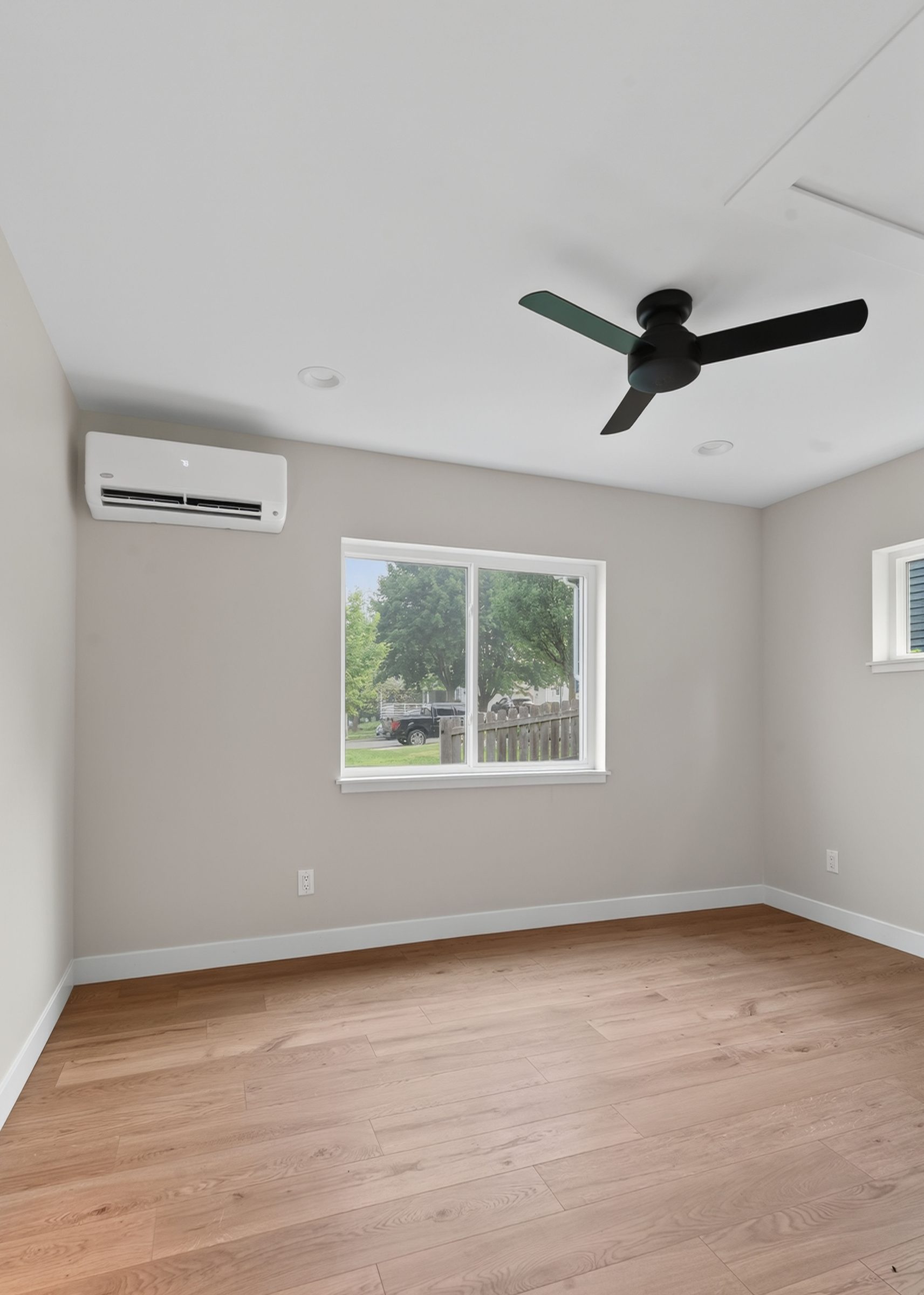 Bedroom with ceiling fan, mini-split, and a wide sliding window — aging-in-place ADU, Madison WI