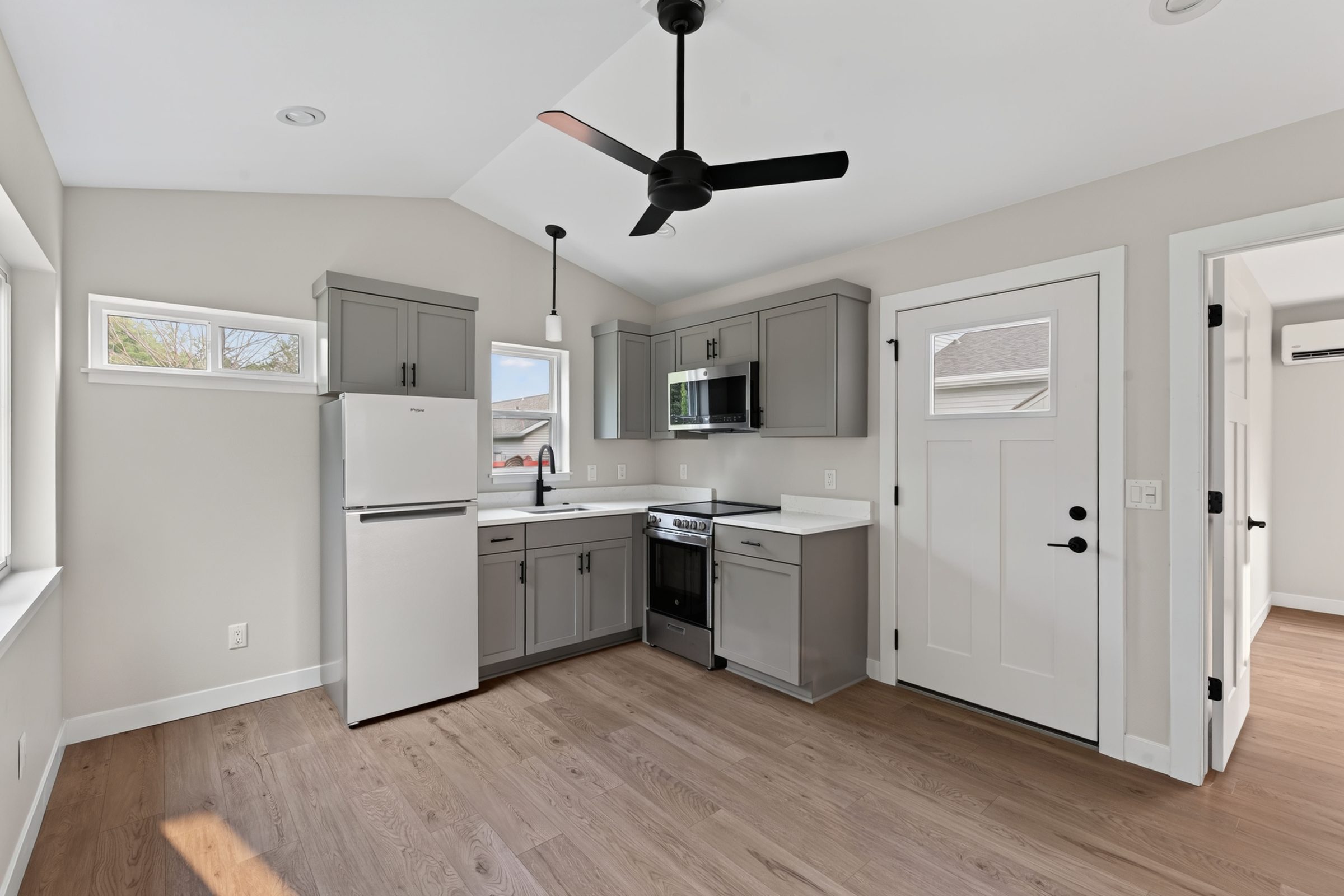Vaulted great room in a Madison, WI aging-in-place ADU, with the kitchen, living area, and entry in one open space