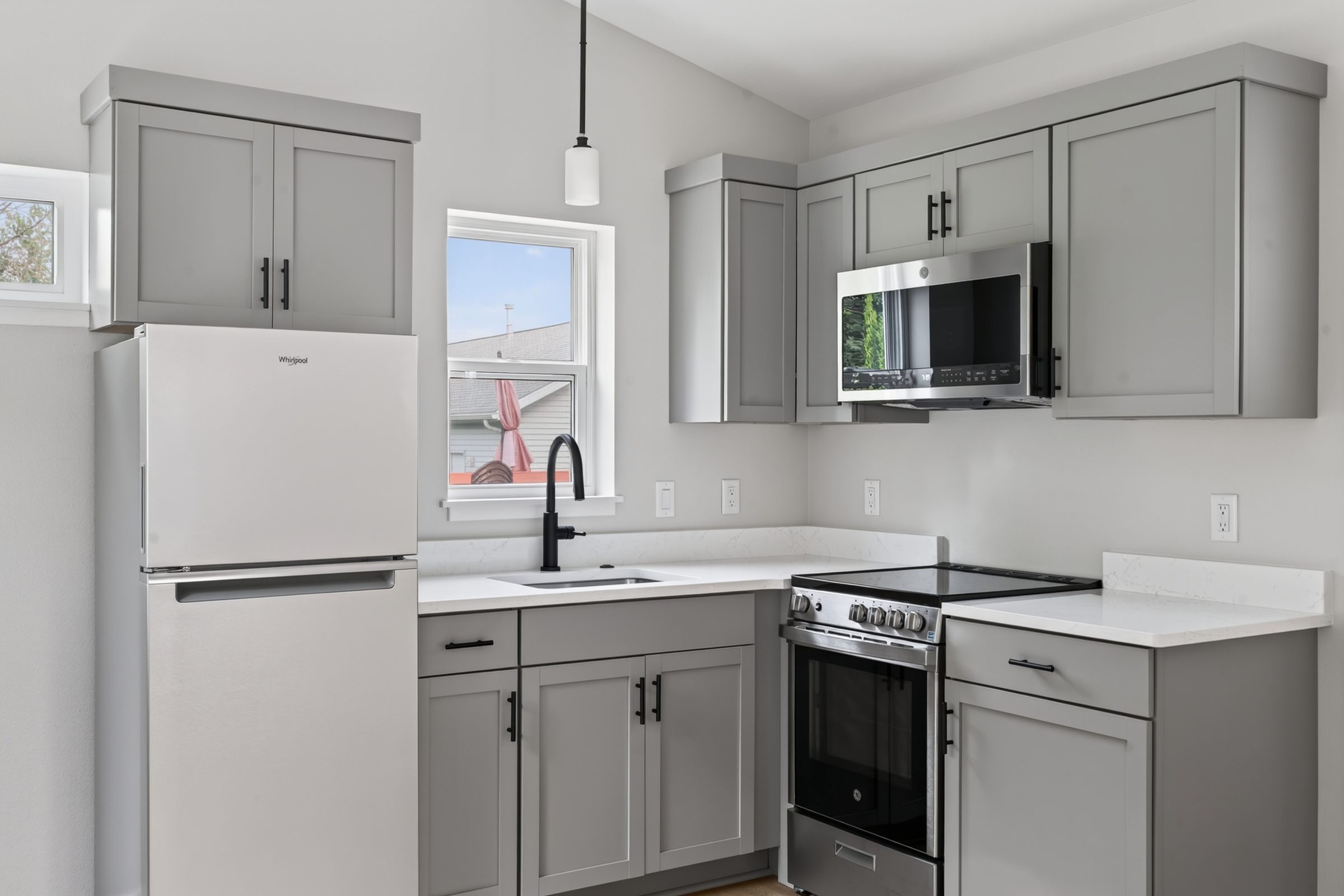 Gray shaker cabinets, black hardware, and a window over the sink — aging-in-place ADU, Madison WI