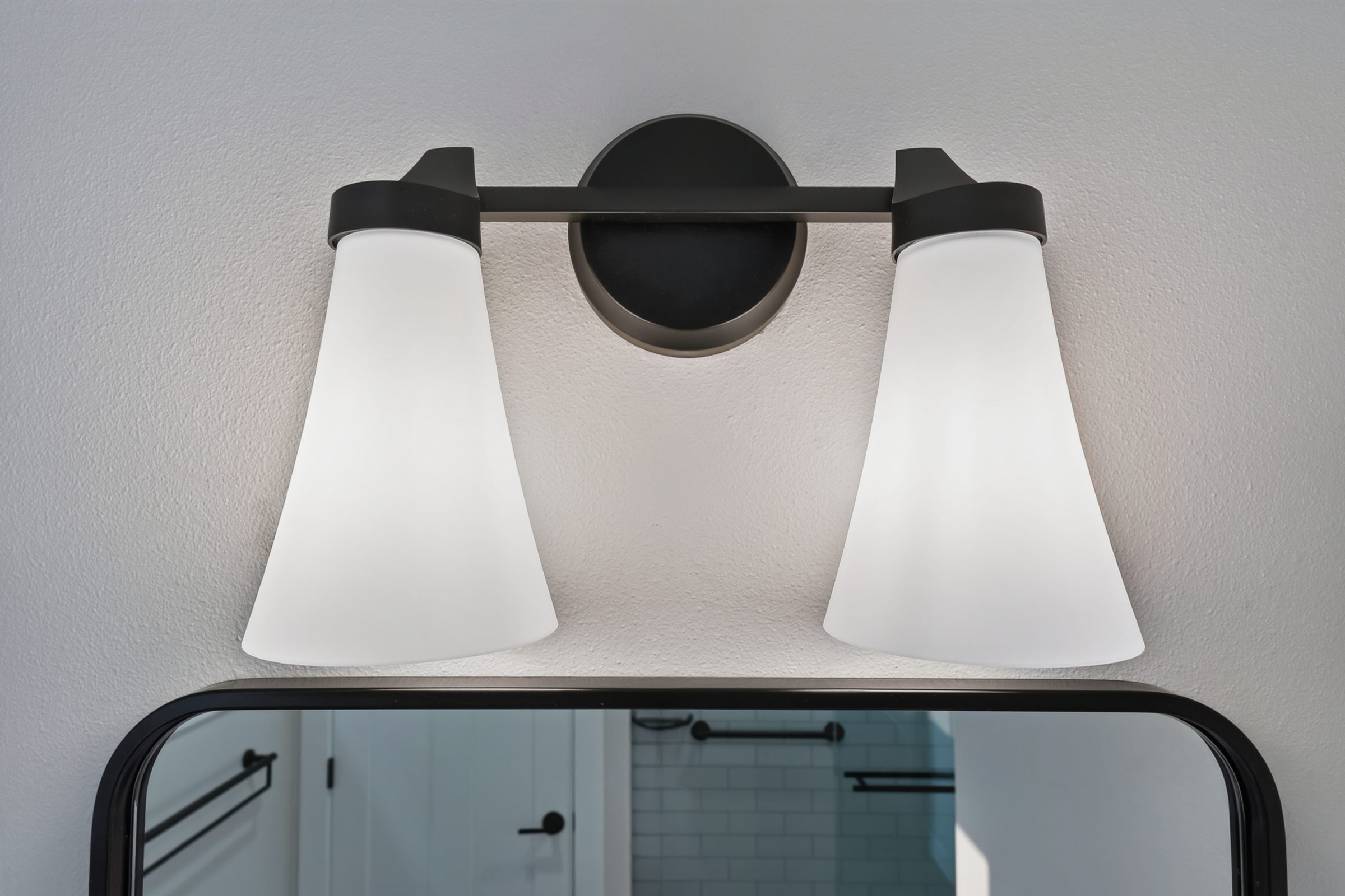 Detail of the two-light vanity fixture — aging-in-place ADU, Madison WI