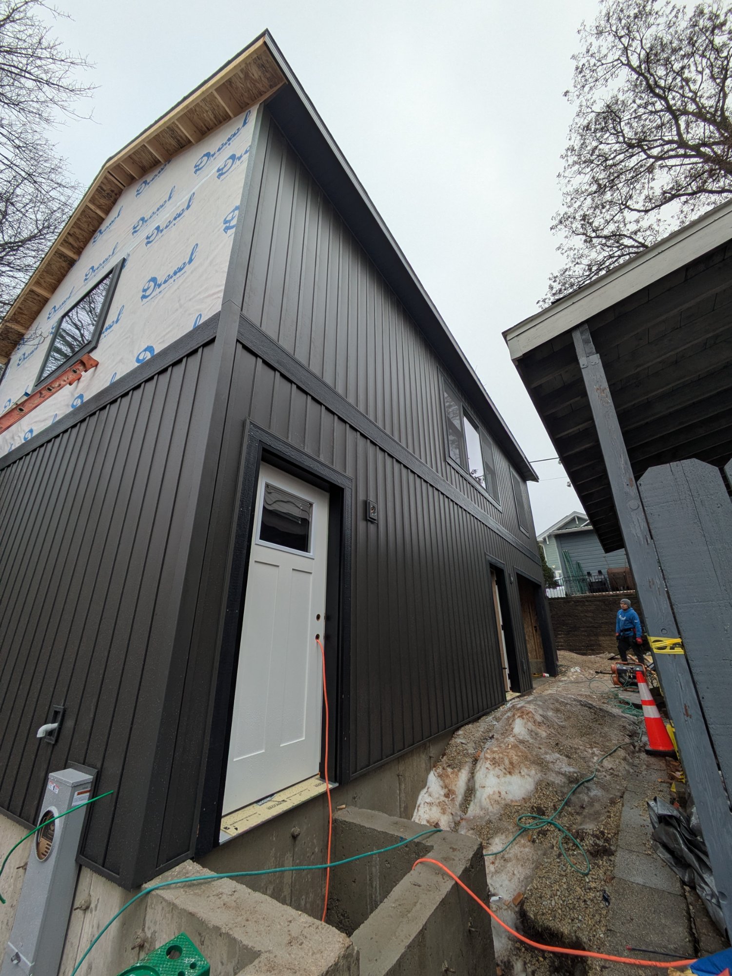Tenant entry door at grade level with new retaining wall and concrete steps — Henry Vilas ADU Madison WI