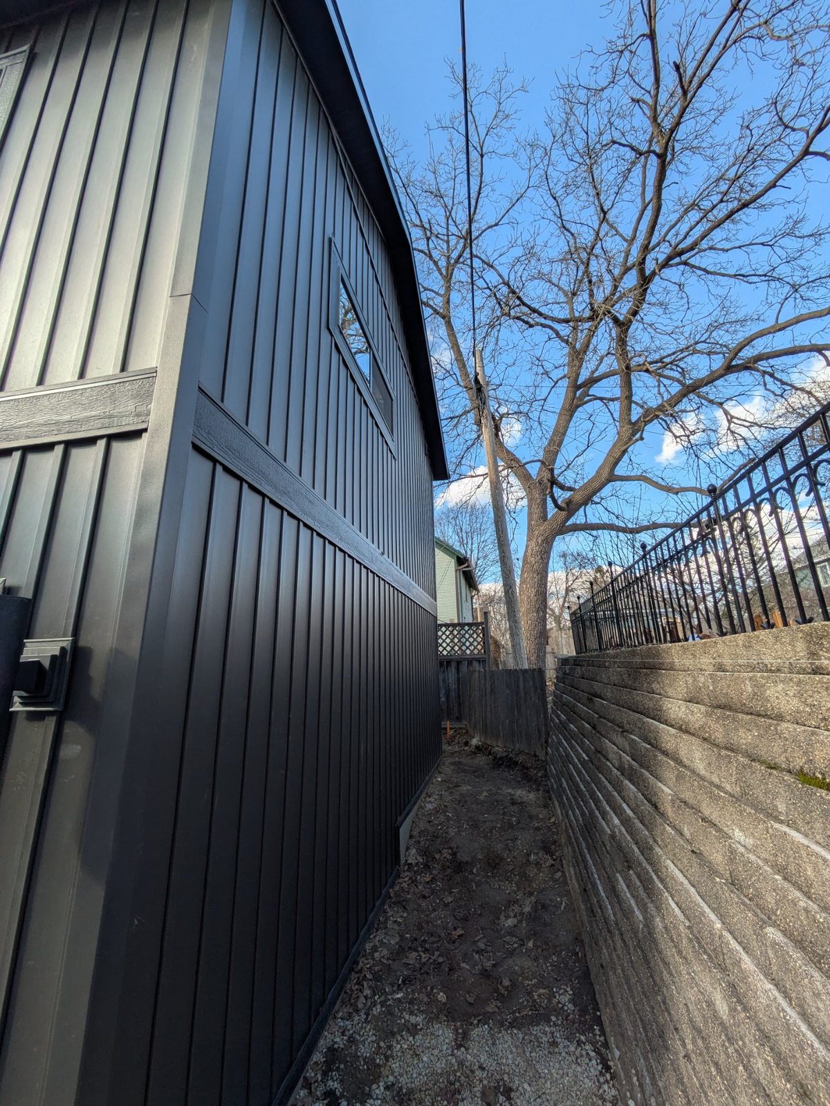 Tight side setback between ADU and retaining wall — Henry Vilas ADU, Madison WI