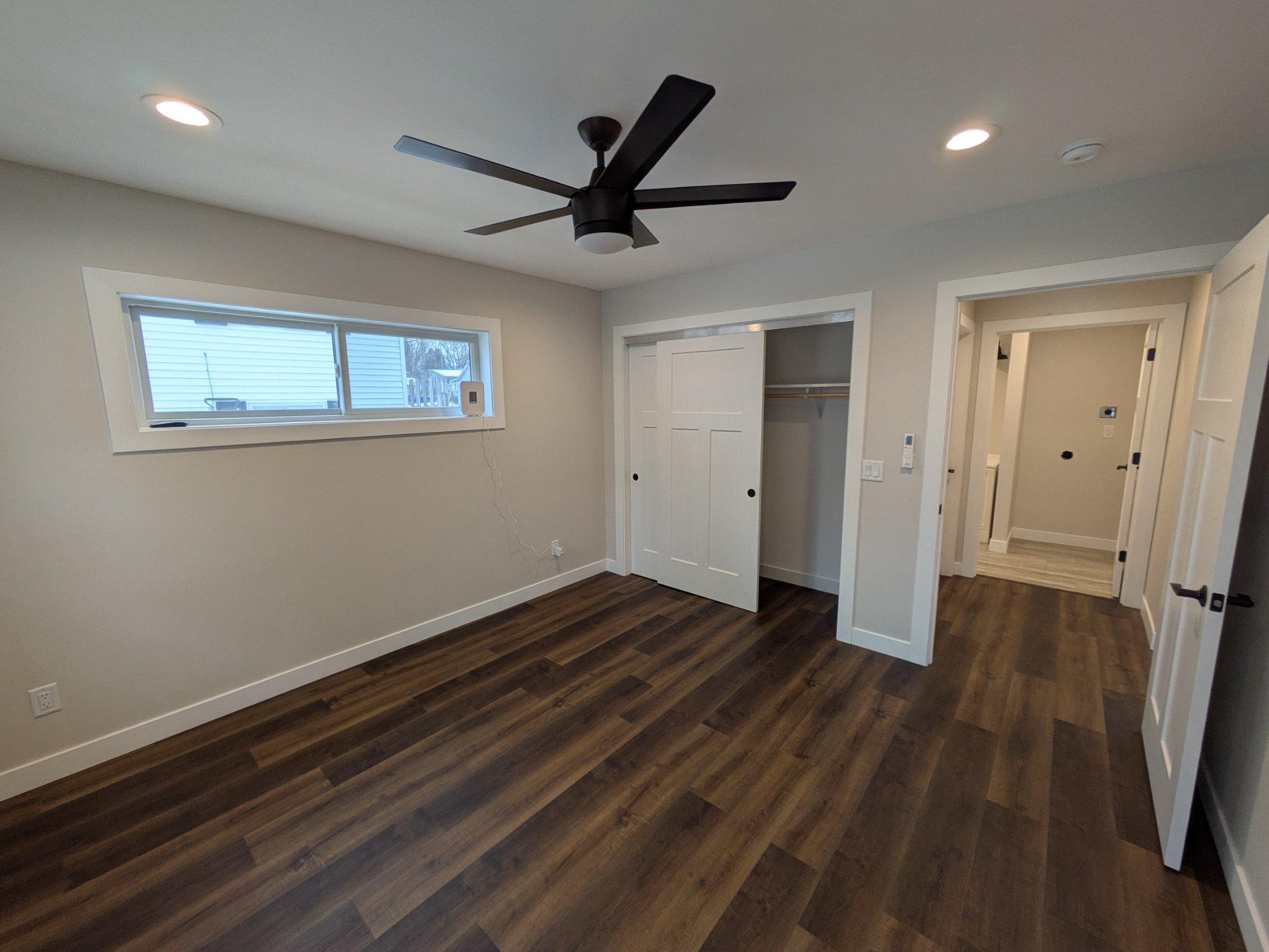 Bedroom with closet, fan, clerestory window — North Side ADU Madison WI