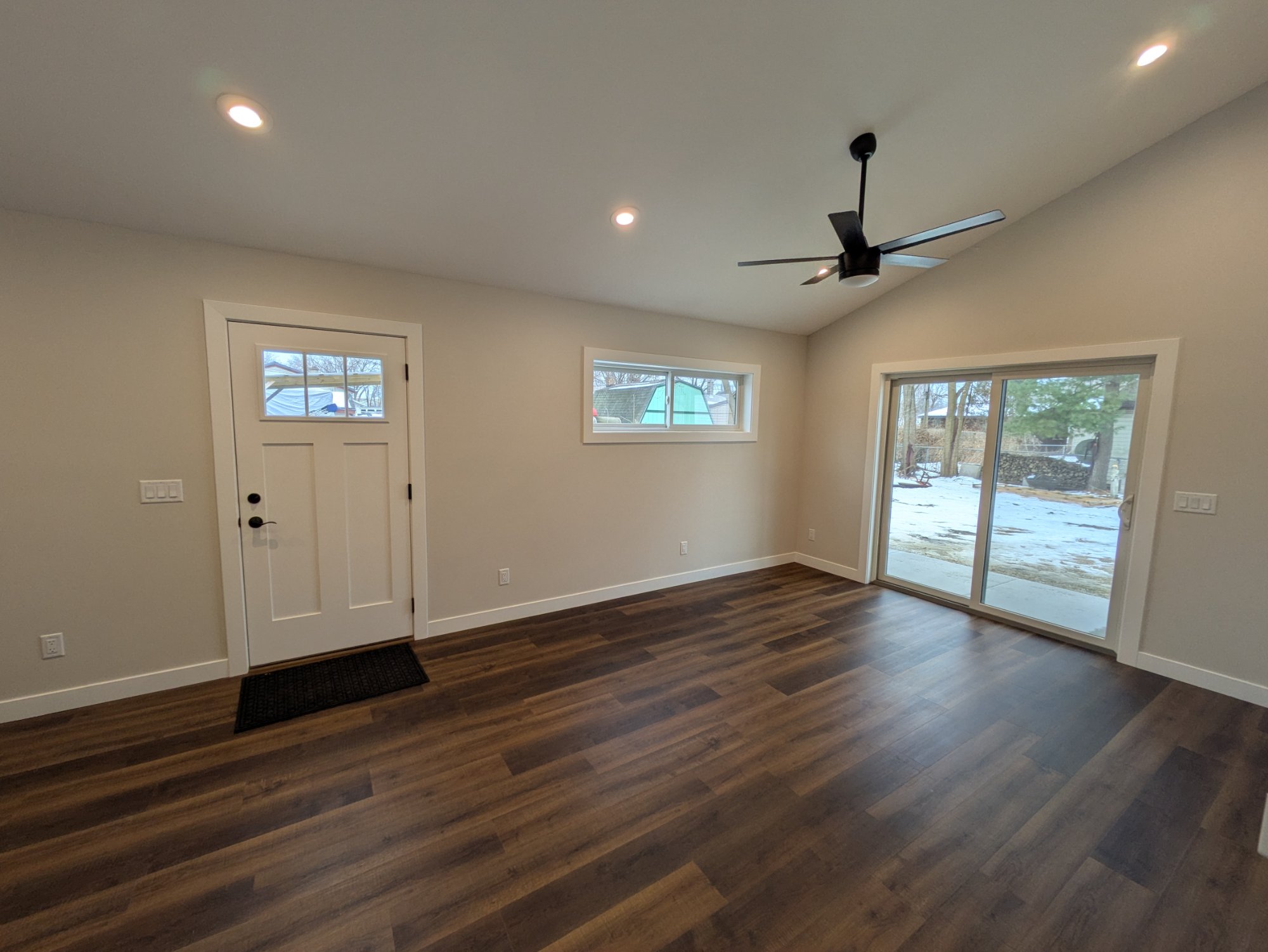 Living area from entry side — craftsman door, clerestory window, slider — North Side ADU Madison WI